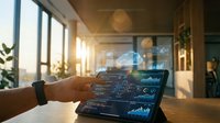 Business professional analyzing financial data on futuristic holographic tablet display in modern office with warm sunlight streaming through windows.