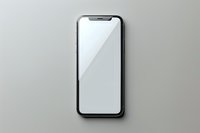 Modern smartphone with blank white screen on light gray background, isolated view for mockup and app design presentation purposes.