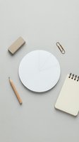 Minimalist office workspace with blank pie chart template, wooden pencil, eraser, paper clip and notebook on neutral beige background for business planning.
