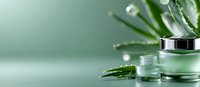Luxury cosmetic jar with aloe vera leaves and water drops on mint green background, natural skincare concept for beauty product packaging and branding.