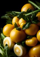 Fresh yellow tomatoes with green parsley leaves on dark background, cut and whole vegetables in moody lighting, macro food photography for restaurant menu.