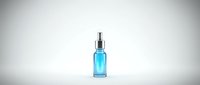 Blue glass serum bottle with silver pump dispenser isolated on white background for skincare and cosmetic product design.
