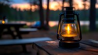 Glowing vintage oil lamp on wooden table at dusk, warm light illuminating dark campground atmosphere with sunset and trees silhouettes in background.