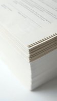 Stack of printed documents with visible text and circular stamp on top page, showing paper edges and depth. Use for business, office, administration, paperwork, and document management concepts.