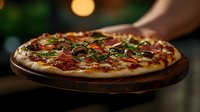 Fresh homemade pizza with melted cheese, pepperoni, mushrooms and herbs served on wooden board against dark background with bokeh lights. Perfect for menu design.