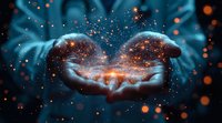 Magical glowing stardust and sparkles floating above cupped hands against dark background, creating ethereal atmosphere with orange and blue light effects.