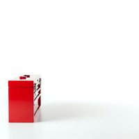 Red gift box with white ribbon bow isolated on white background for holiday celebrations and special occasions.