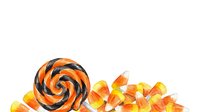 Striped orange and black lollipop with scattered candy corn isolated on white background, ready for design projects and seasonal marketing materials.