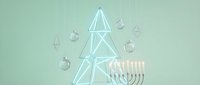 Modern minimalist Hanukkah celebration with geometric wire Christmas tree and lit menorah on sage green background for holiday decor and greeting cards.