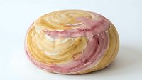 Freshly baked spiral pastry with pink and golden swirl layers, isolated on white background, ready for bakery, food, and culinary design projects.
