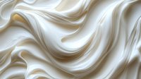 Smooth flowing cream silk fabric with elegant waves and soft folds creating luxurious textile background for fashion and interior design projects.