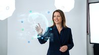 Confident Caucasian businesswoman in navy suit interacting with glowing holographic digital interface, global network data visualization in modern office.