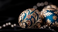 Ornate Christmas baubles in deep blue and gold featuring delicate floral patterns and swirling designs against dark background, elegant holiday decorations.
