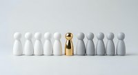 Golden figure standing out among white and gray wooden pawn pieces on white background representing leadership, uniqueness and business success concept.