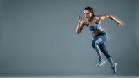 Fit young woman with athletic build sprinting in mid-air against neutral background, wearing blue sports bra and leggings, ideal for fitness, wellness, and athletic lifestyle marketing.