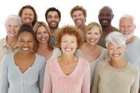 Diverse group of smiling adults of various ages and ethnicities wearing casual attire, representing community, teamwork, and inclusivity.