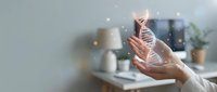 Young woman with light skin tone wearing white long-sleeved shirt holding glowing DNA helix hologram in modern office workspace. Suitable for biotechnology, genetic research, science innovation, and medical technology concepts.