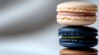 Colorful French macarons stacked together with creamy filling, delicate almond cookies perfect for bakery menus, dessert photography and culinary designs.