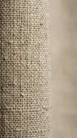 Natural burlap fabric texture close-up with woven hemp fibers in beige tones for rustic interior design and craft projects.