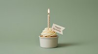 Minimalist birthday cupcake with lit candle and Happy Birthday flag on soft green background, perfect for celebration cards and invitations.