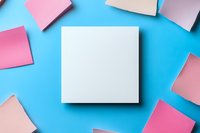 White square note paper surrounded by pink sticky notes on bright blue background, creating minimal geometric composition for business communication and planning.