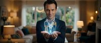 Professional businessman holding glowing digital house model in modern living room representing real estate technology and smart home innovation concepts.