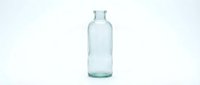 Empty clear glass bottle isolated on white background for product packaging design and branding projects.
