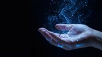 Open palm holding glowing blue digital particles and light streams against dark background for technology and innovation concepts.
