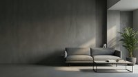 Modern minimalist living room interior with gray sofa and concrete wall. Contemporary home design with natural lighting and green plant decor.