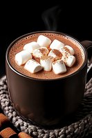 Hot chocolate topped with marshmallows in dark ceramic mug on knitted coaster. Steam rising, marshmallows dusted with cocoa powder against black background.