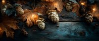 Autumn composition with golden fairy lights, pine cones, and dried maple leaves on rustic wooden background. Cozy seasonal decoration.