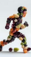Creative food art showing running human figure made from colorful jelly beans, blackberries, and various beans on white background, healthy lifestyle concept.