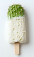 Creative cactus-shaped popsicle with green top and white coconut base on wooden stick isolated on white background for summer dessert concepts.
