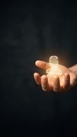 Hand holding glowing user icon symbol against dark background, representing digital connection, customer service, social media engagement, and online community support for business applications.