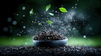 Organic soil explosion with green leaves floating in dark bowl against blurred natural background. Dynamic composition showing growth and fertility in gardening.