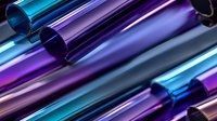 Metallic tubes in vibrant blue and purple colors arranged diagonally creating dynamic composition with glossy reflective surfaces and gradient effects.
