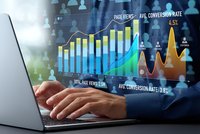 Business professional analyzing digital marketing analytics with holographic data visualization charts showing conversion rates and performance metrics on laptop.