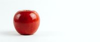 Fresh red apple isolated on white background for healthy eating and nutrition concepts.