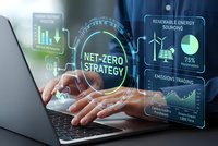 Businessman hands typing on laptop with holographic net-zero strategy interface displaying renewable energy data and carbon emissions trading analytics.