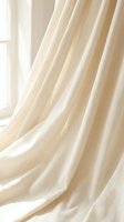 Elegant cream linen curtains flowing gracefully by bright window creating soft natural lighting and cozy atmosphere for home interior design projects.