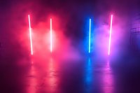 Glowing neon light tubes in pink and blue colors with smoke effects create atmospheric mood on reflective concrete floor in dark room, perfect for nightclub backdrop.