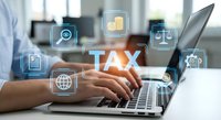 Professional accountant working on laptop with digital tax management icons and financial technology interface for business taxation services.
