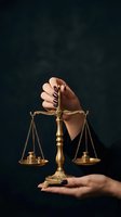 Female hands holding golden scales of justice on dark background symbolizing law, legal system, fairness and judicial balance for legal services.