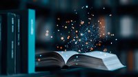 Magical open book with glowing sparkles and light particles rising in dark room against blurred bookshelf background, creating mystical reading atmosphere.