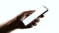 Male hand holding smartphone with blank white screen against light background for mobile app mockup and digital communication concepts.