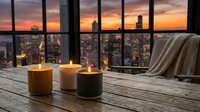 Three lit candles on wooden table by window overlooking city skyline at sunset. Cozy interior design with warm lighting and urban view for relaxation concepts.