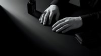 Professional businessman hands on dark desk with smartphone in dramatic black and white lighting for corporate business concepts and office workspace designs.