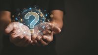 Hands of a middle-aged male with medium skin tone holding glowing question mark symbol surrounded by digital icons and particles, representing inquiry, problem-solving, and customer support solutions.