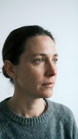 Middle-aged Caucasian woman in gray sweater looking thoughtfully away, natural lighting portrait for mental health and wellness campaigns.