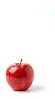 Fresh red apple with water droplets on white background for healthy eating and nutrition concepts.